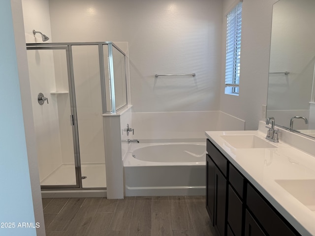 bathroom with separate shower and tub, hardwood / wood-style flooring, and vanity