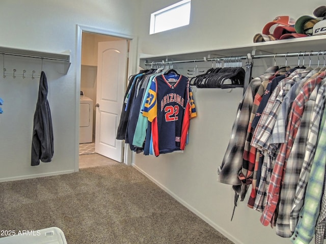 spacious closet with washer / dryer and carpet flooring