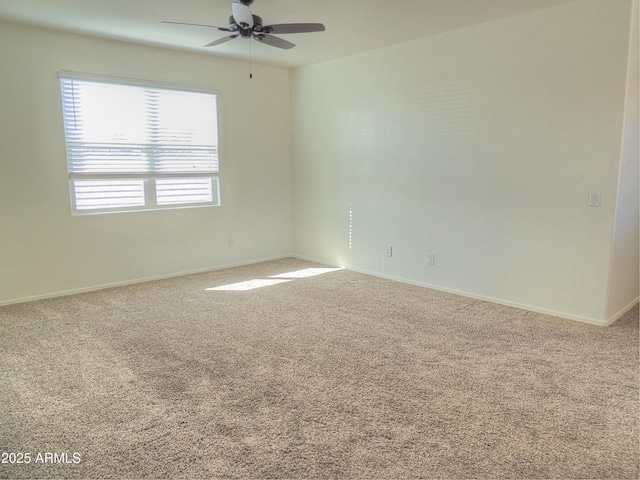 unfurnished room with ceiling fan and carpet flooring