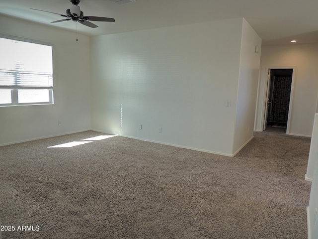 carpeted empty room featuring ceiling fan