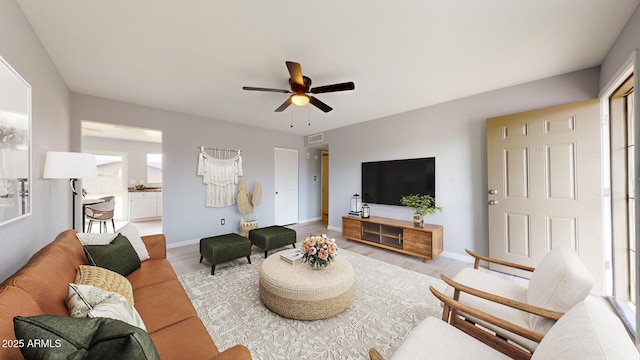 living room with ceiling fan and light hardwood / wood-style floors