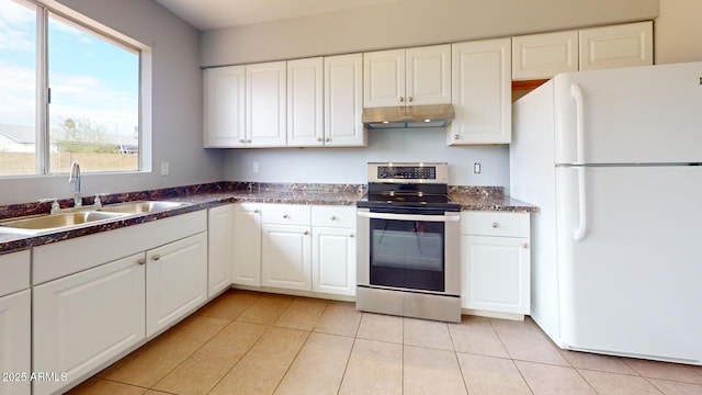 kitchen featuring sink, white cabinetry, stainless steel electric range oven, light tile patterned floors, and white refrigerator