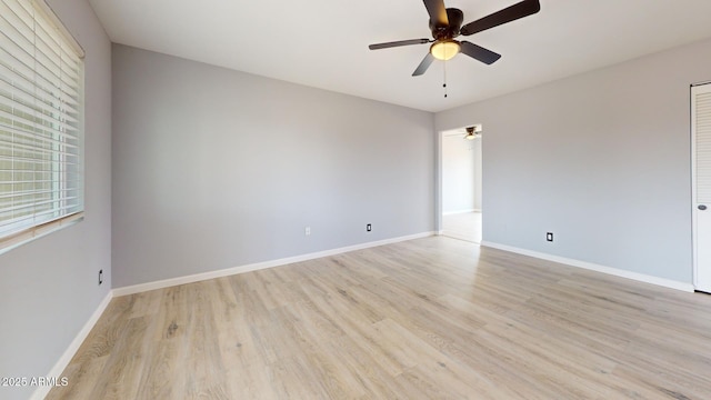 spare room with ceiling fan and light wood-type flooring