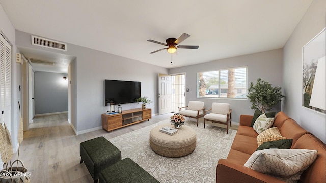 living room with ceiling fan and light hardwood / wood-style flooring