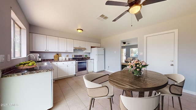 kitchen with sink, electric range, white refrigerator, a wealth of natural light, and white cabinets