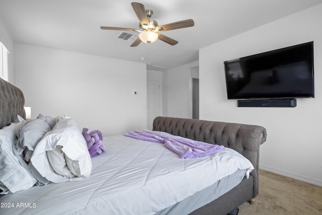 carpeted bedroom with ceiling fan, visible vents, and baseboards