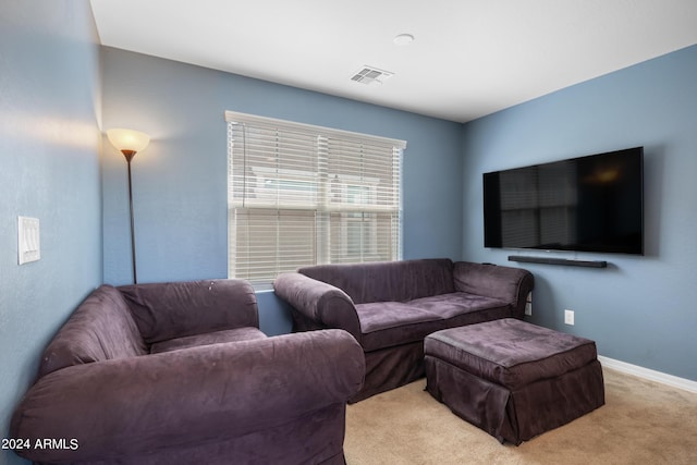 carpeted living room with visible vents and baseboards