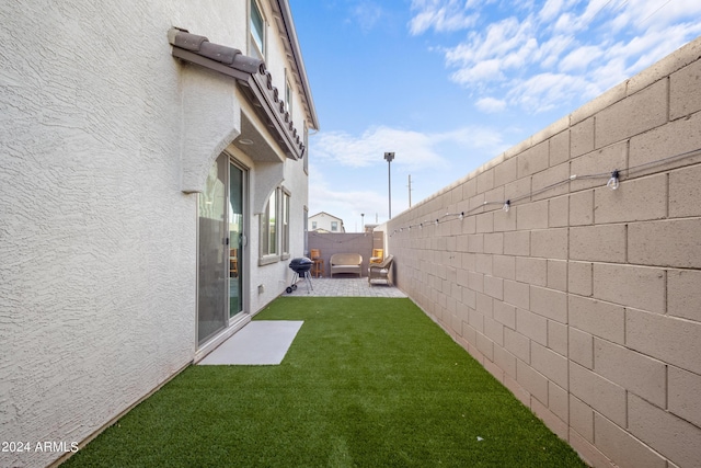 view of yard featuring a patio and a fenced backyard