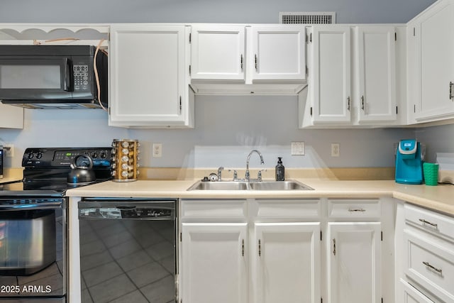 kitchen featuring white cabinetry, sink, tile patterned floors, and black appliances