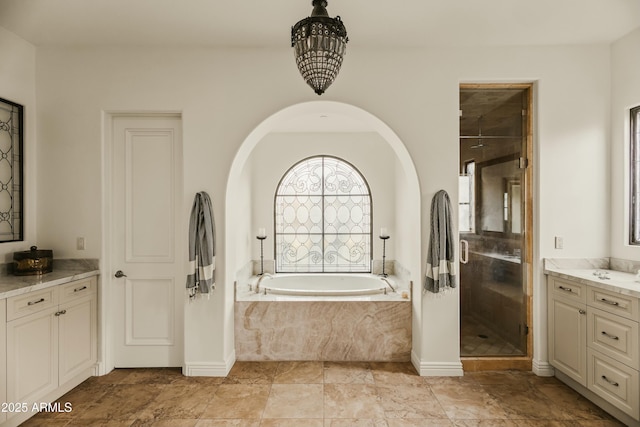 full bath with a stall shower, a garden tub, and vanity