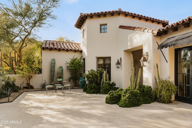 back of house featuring a patio area and stucco siding