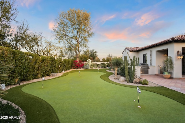 surrounding community with exterior kitchen and a patio