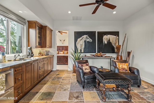 kitchen featuring recessed lighting, stone tile flooring, a sink, and tile countertops