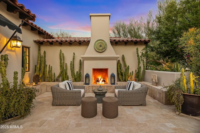 view of patio / terrace with an outdoor living space with a fireplace