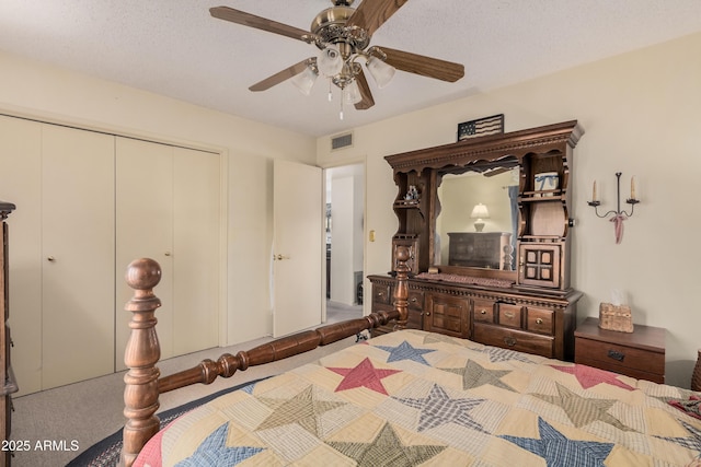 carpeted bedroom featuring ceiling fan and a textured ceiling