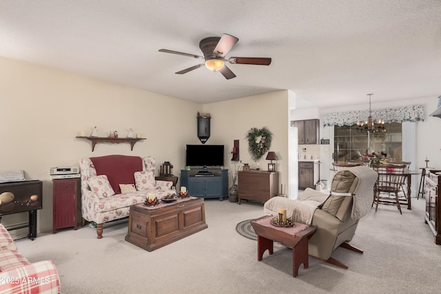 living room featuring light colored carpet, a baseboard heating unit, and ceiling fan with notable chandelier