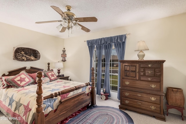 bedroom featuring ceiling fan, light colored carpet, and a textured ceiling