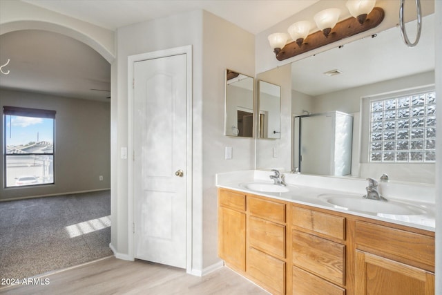 bathroom featuring vanity, hardwood / wood-style flooring, and walk in shower