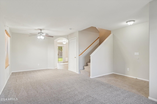 spare room with ceiling fan and light colored carpet