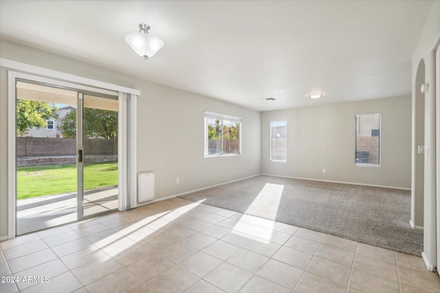 unfurnished room featuring light tile patterned floors and a wealth of natural light