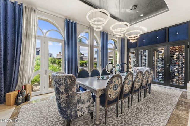7475 E Gainey Ranch Rd Unit 22, Scottsdale, AZ 85258 - dining area with french doors, a high ceiling, and a chandelier