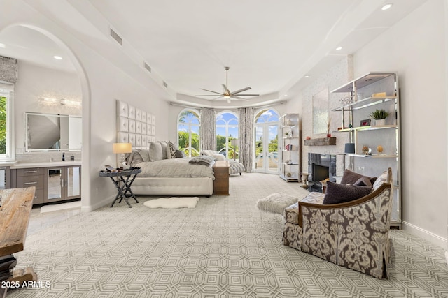 7475 E Gainey Ranch Rd Unit 22, Scottsdale, AZ 85258 - living area featuring ceiling fan, a large fireplace, carpet floors, recessed lighting, and a tray ceiling