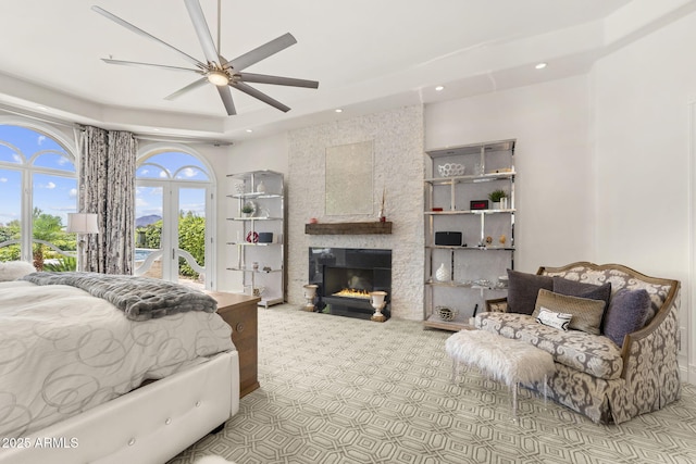 7475 E Gainey Ranch Rd Unit 22, Scottsdale, AZ 85258 - bedroom with carpet flooring, a fireplace, recessed lighting, ceiling fan, and a tray ceiling