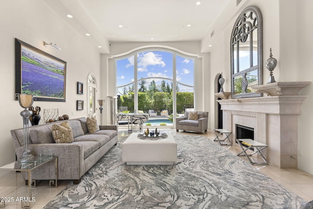 7475 E Gainey Ranch Rd Unit 22, Scottsdale, AZ 85258 - tiled living area featuring a high ceiling, a high end fireplace, and recessed lighting