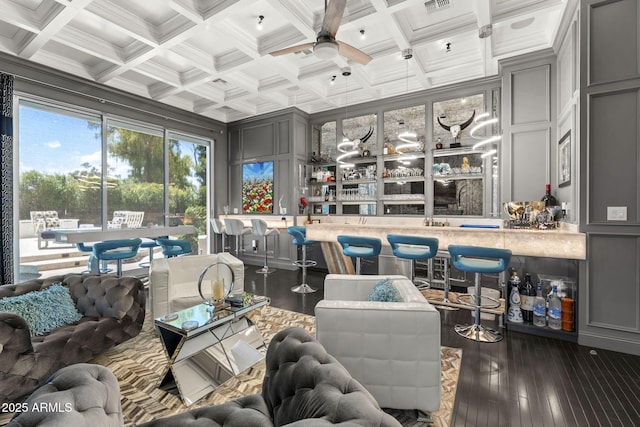 7475 E Gainey Ranch Rd Unit 22, Scottsdale, AZ 85258 - living area featuring bar area, a decorative wall, a ceiling fan, dark wood finished floors, and coffered ceiling