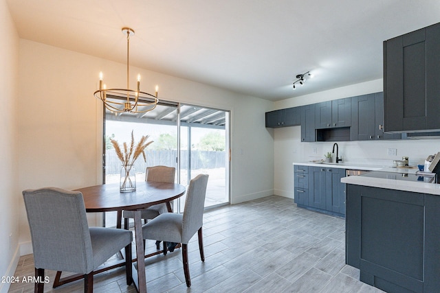 kitchen featuring a chandelier, decorative light fixtures, light hardwood / wood-style floors, and sink