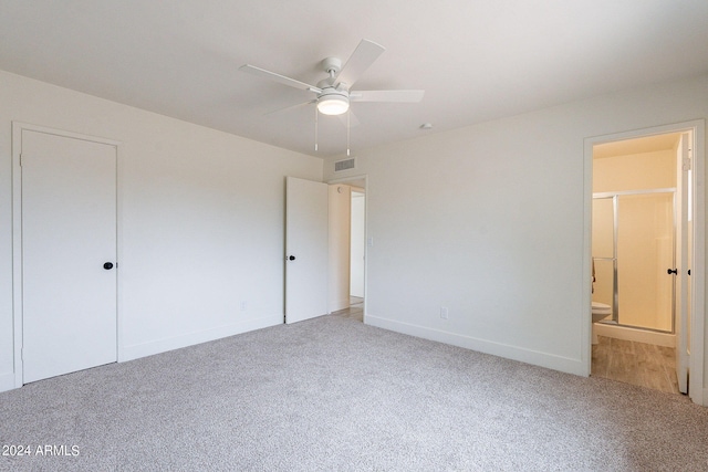 unfurnished bedroom with ensuite bath, a closet, ceiling fan, and carpet