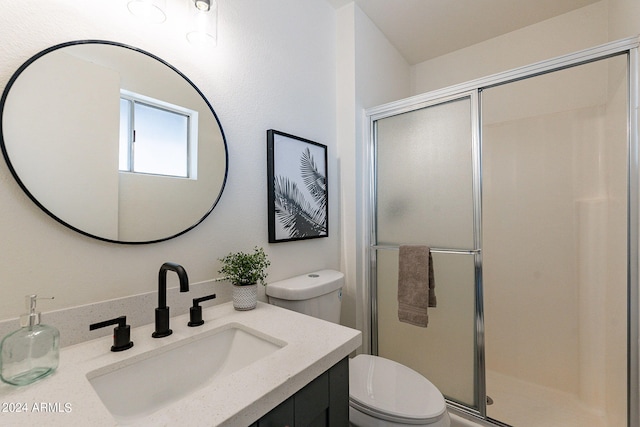 bathroom with vanity, an enclosed shower, and toilet