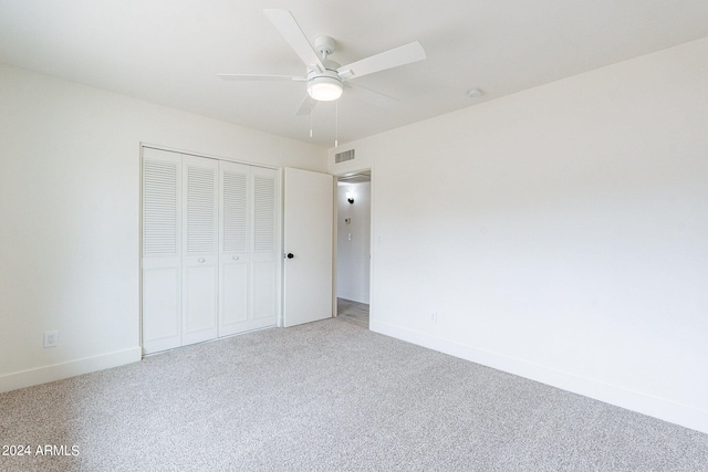 unfurnished bedroom featuring a closet, ceiling fan, and carpet