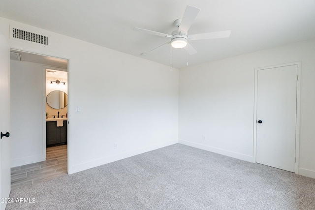 empty room with ceiling fan and carpet