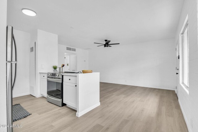 interior space featuring white cabinetry, electric range, and ceiling fan