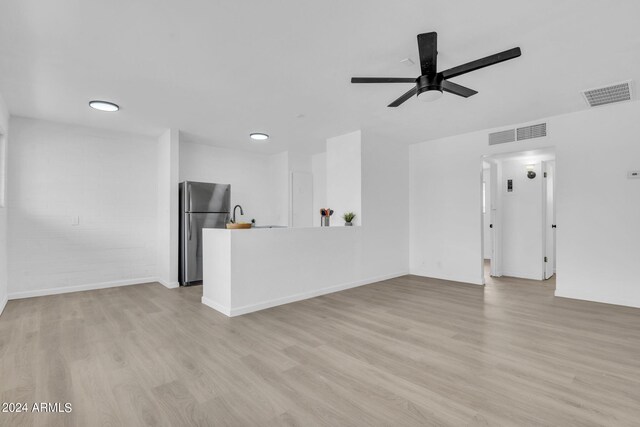 kitchen featuring white cabinetry, appliances with stainless steel finishes, ceiling fan, and light wood-type flooring