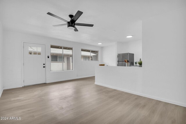 kitchen featuring stainless steel appliances, white cabinets, and light hardwood / wood-style flooring