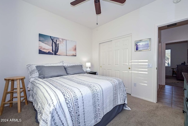 carpeted bedroom featuring a closet and ceiling fan