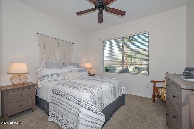 bedroom with light carpet and ceiling fan