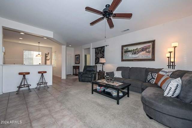 living room featuring light tile patterned floors and ceiling fan