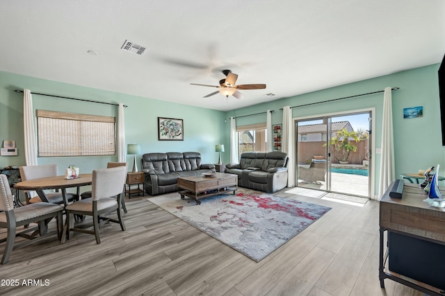 living room featuring ceiling fan and light wood-type flooring