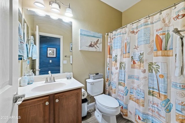 bathroom with a shower with curtain, vanity, and toilet