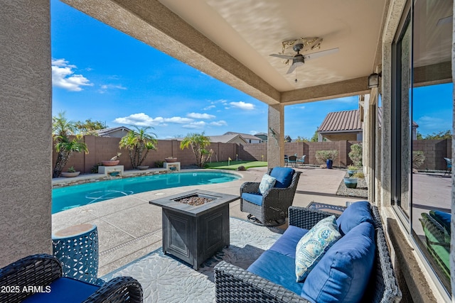 view of patio featuring a fenced in pool, ceiling fan, and an outdoor fire pit