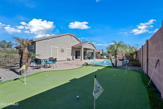 exterior space featuring a patio and a fenced in pool