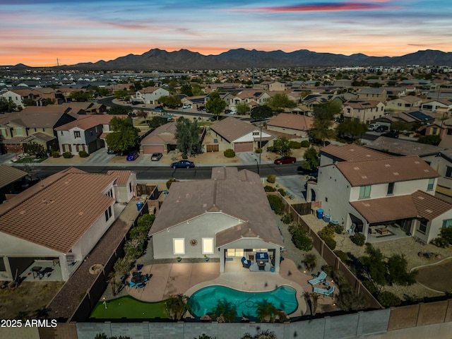 aerial view at dusk featuring a mountain view