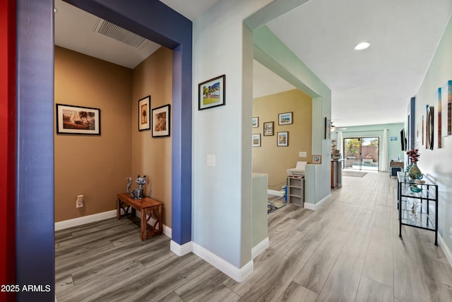 hall with light hardwood / wood-style floors