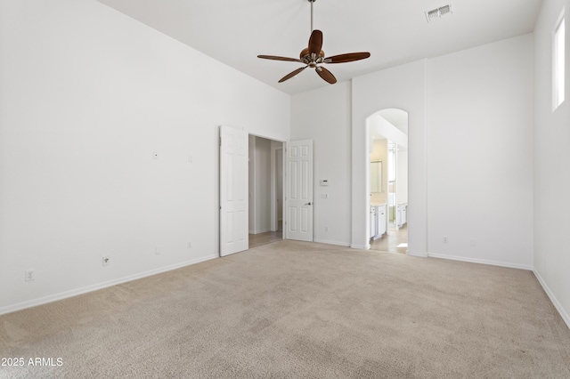 5892 E Evening Glow Dr, Scottsdale, AZ 85266 - empty room featuring a ceiling fan, light colored carpet, visible vents, and arched walkways
