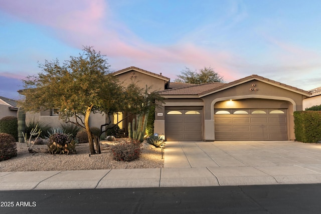5892 E Evening Glow Dr, Scottsdale, AZ 85266 - view of front facade featuring an attached garage, a tiled roof, concrete driveway, and stucco siding