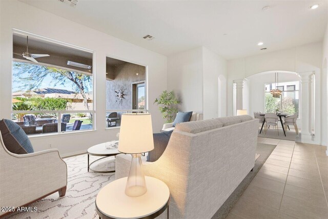 5892 E Evening Glow Dr, Scottsdale, AZ 85266 - tiled living area featuring plenty of natural light, arched walkways, visible vents, and decorative columns