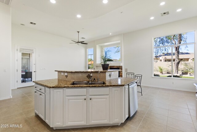 5892 E Evening Glow Dr, Scottsdale, AZ 85266 - kitchen with dark stone countertops, a center island with sink, white cabinetry, and a sink